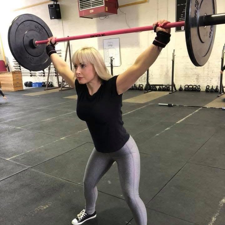 Joanna holding a barbell overhead in an overhead squat