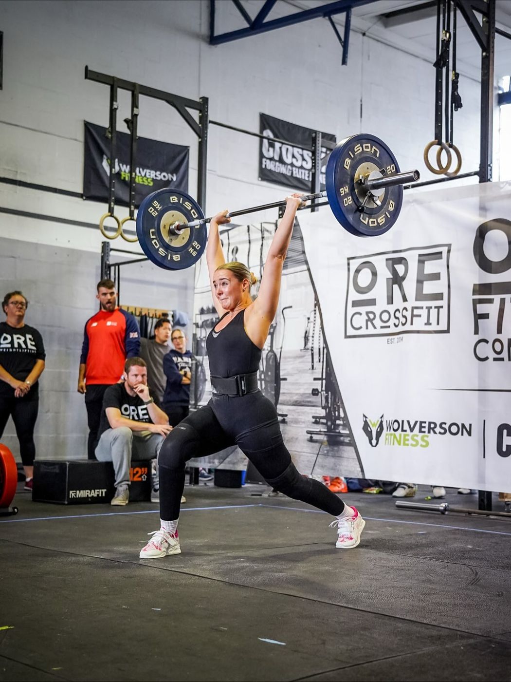 A member catching a split jerk at an ORE weightlifting competition