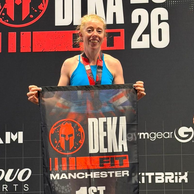 Vic smiling on the podium at a fitness race